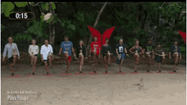a group of people standing on a beach with the time of 15:15