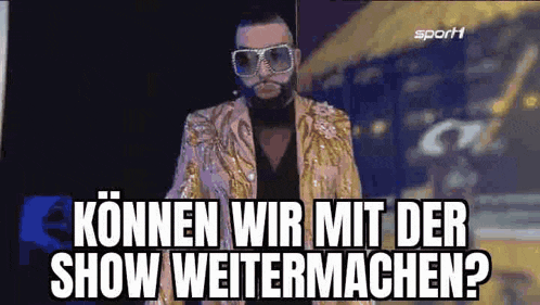 a man in a gold suit and sunglasses is standing in front of a sign that says können wir mit der show weitermachen