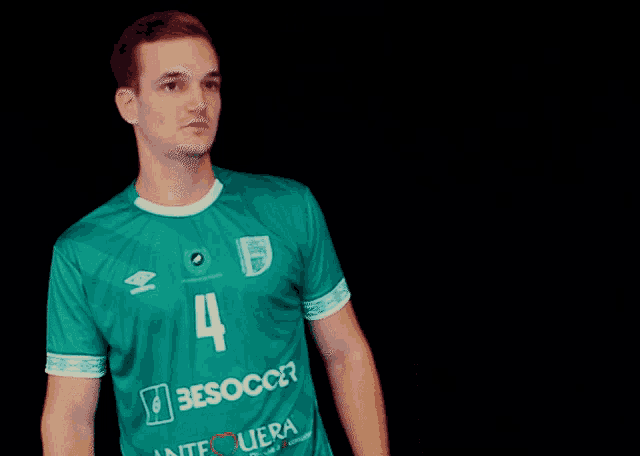 a man wearing a green jersey with the number 4 on the front