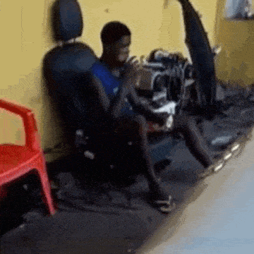 a man is sitting in a chair with his legs crossed in a room .