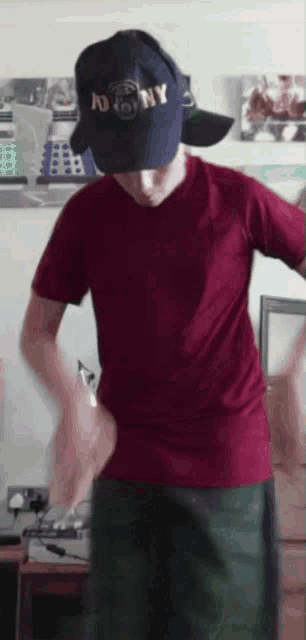 a man wearing a hat that says ny on it is dancing