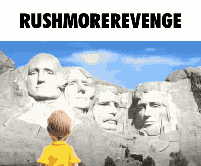 a boy in a yellow shirt stands in front of the rushmore memorial