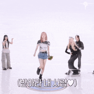 a girl with pink hair is holding a bouquet of red roses in front of a group of people with korean writing on them