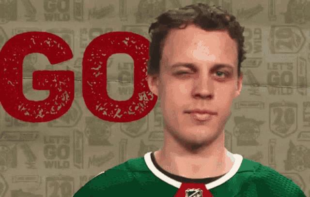a hockey player winks in front of a background that says go