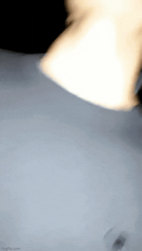 a close up of a person 's neck in a dark room with a light shining on it .