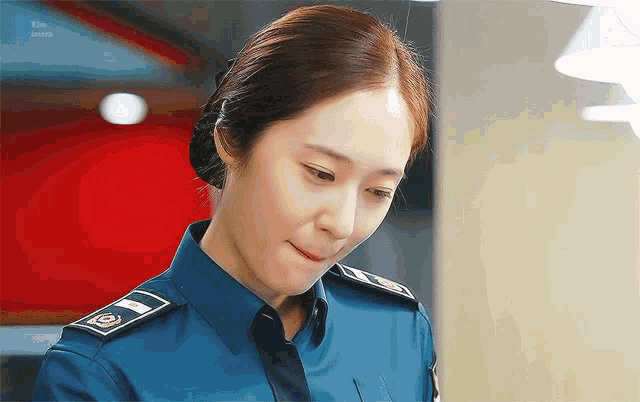 a woman in a police uniform has a badge on her shoulder
