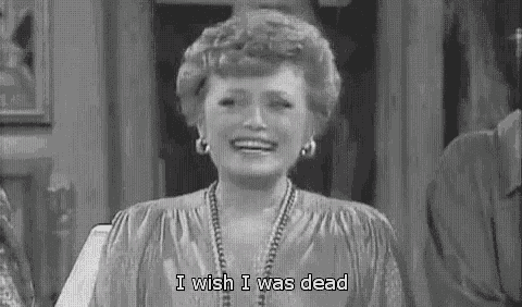 a black and white photo of a woman laughing with the words `` i wish i was dead '' .