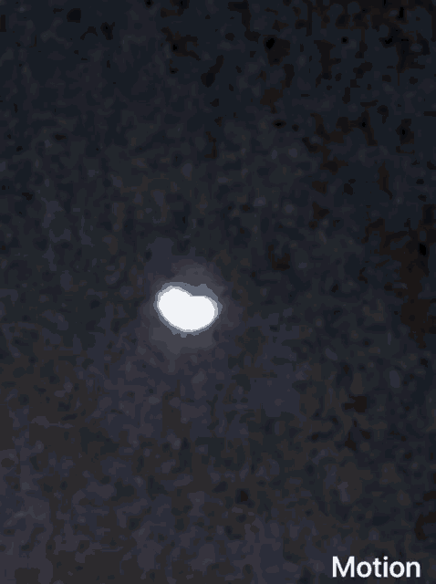a black background with a white circle in the middle and the word motion underneath