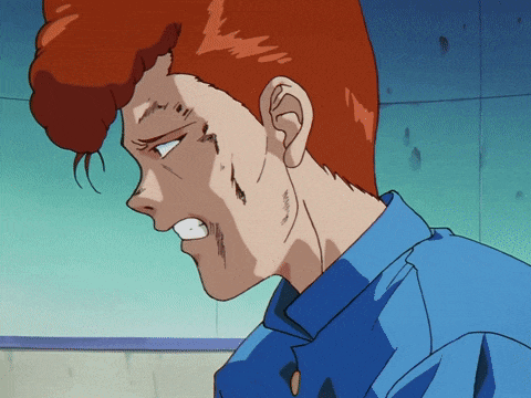 a man with red hair is wearing a blue shirt and making a face