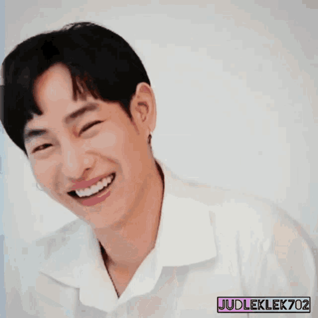 a young man in a white shirt is smiling with judleklek702 written on the bottom