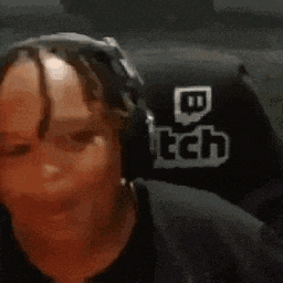 a woman is wearing headphones and sitting in a chair with a twitch logo on it .