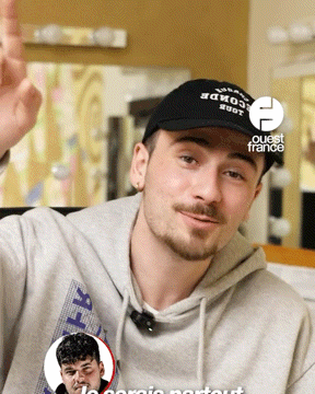 a man wearing a black hat that says " coca cola " on it