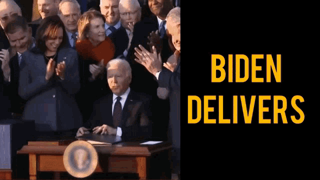 a man in a suit and tie is signing a document in front of a crowd of people with the words biden delivers below him