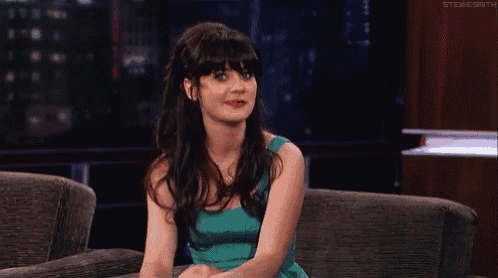 a woman in a green dress is sitting on a couch with a caption that says stevesmith