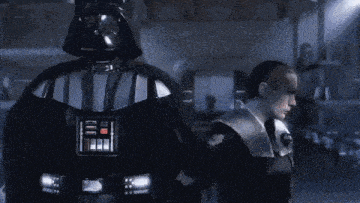darth vader is standing next to a police officer in a garage .
