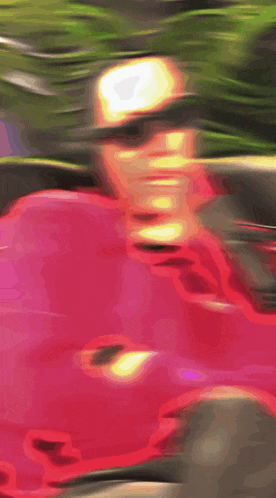 a blurry picture of a person wearing sunglasses in a pink car