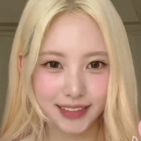 a close up of a woman with blonde hair and pink cheeks