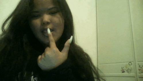 a girl with long white nails is making a silly face