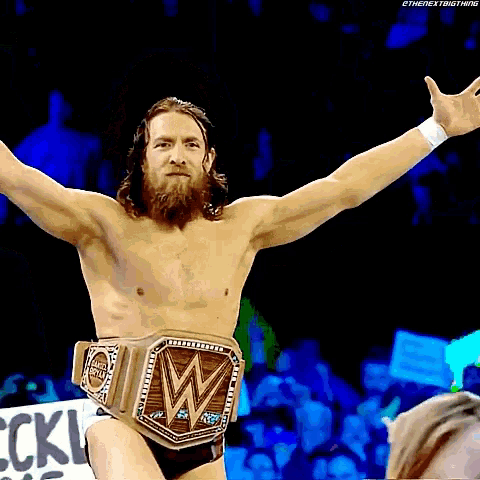 a man with a beard is wearing a wrestling belt that says w on it
