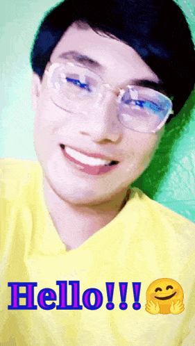 a young man wearing glasses and a yellow shirt says hello