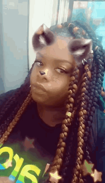 a girl with braids is wearing a t-shirt with the word sio on it
