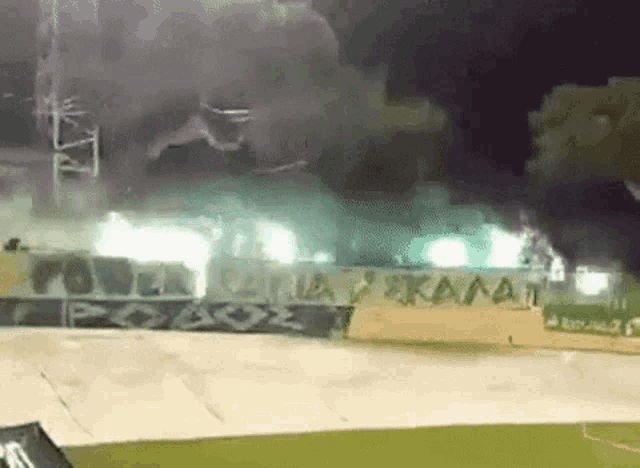 smoke is coming out of a soccer stadium with a banner that says skala on it