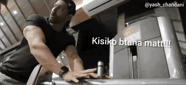a man in a black shirt is standing in front of a refrigerator with the words kisiko btana matti written on it