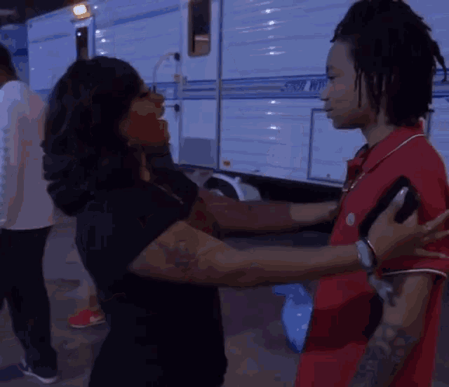 a woman is hugging a man in front of a trailer that says storm northwest