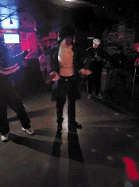 a blurry photo of people in a dark room with a sign that says ' coca cola ' on it