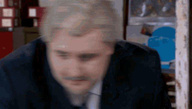 a blurry picture of a man 's face in a suit and tie