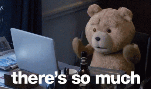 a teddy bear is sitting at a desk in front of a laptop with the words " there 's so much " below it