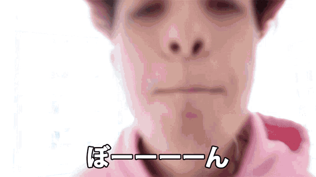 a close up of a person 's face with a pink shirt and a pink hat .