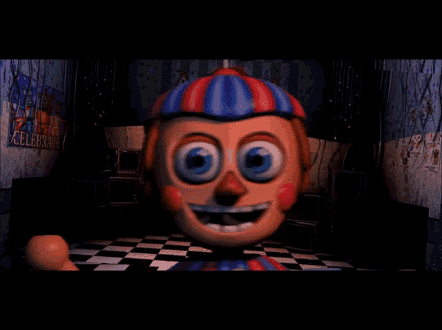 a balloon boy is smiling in a dark room with a sign that says celebrate