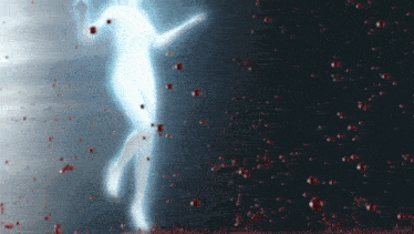 a silhouette of a person is surrounded by red drops