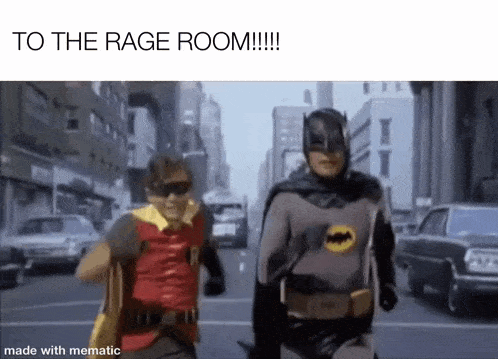 batman and robin are running down the street in a city .