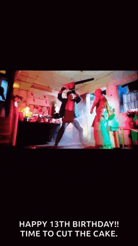 a man is holding a chainsaw in his hand while a woman stands behind him .