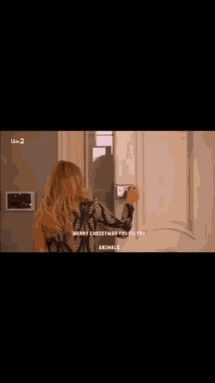 a woman is opening a door with the words merry christmas you filthy animals on the bottom