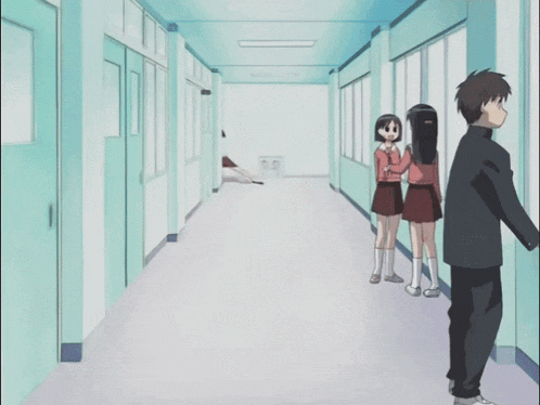 a girl is running down a hallway while a boy looks on