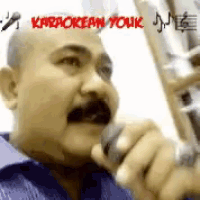 a man with a mustache is singing into a microphone with karaokean youk written on the bottom