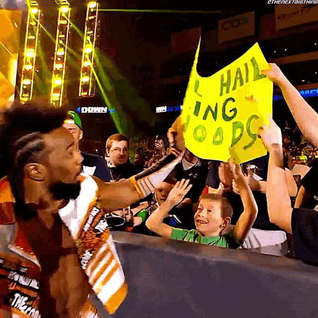 a man holding a sign that says " hail ing odds "