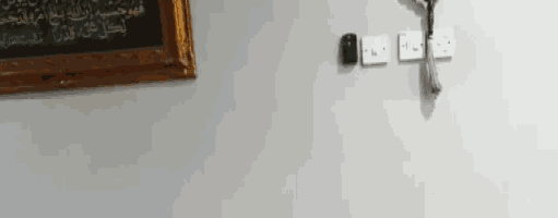 a picture of a cross is hanging on a wall next to a picture of a bible .