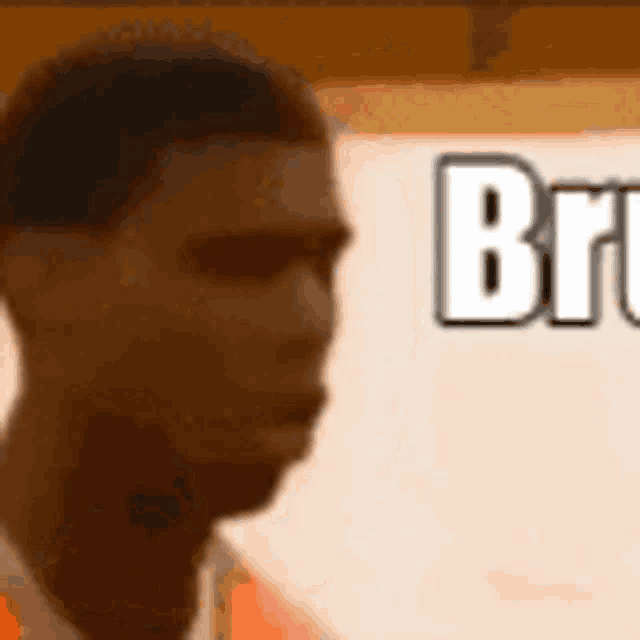 a close up of a man 's face in front of a sign that says bruce