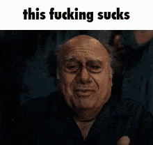 a man with a sad look on his face is making a funny face .