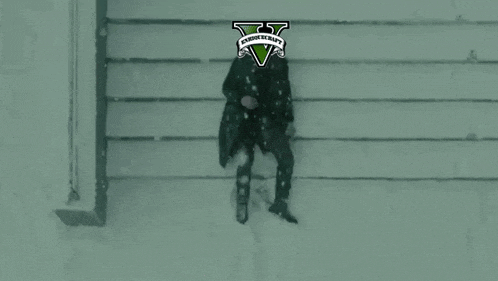 a man is sitting in the snow with a logo for grand theft auto 5