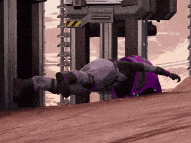a person in purple pants is laying on their back in front of a building