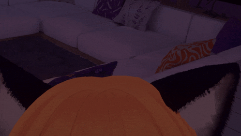 a white couch with purple pillows and a black pillow