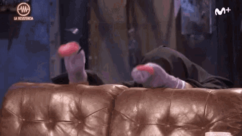 a person is laying on a couch with their feet up and the letters m + on the bottom