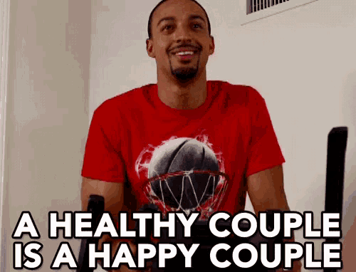 a man wearing a red t-shirt with a basketball on it says a healthy couple is a happy couple