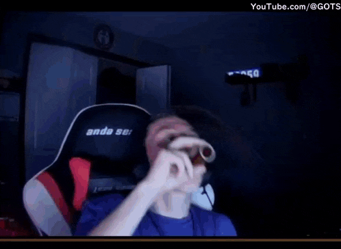 a boy wearing headphones is sitting in an anda seat gaming chair