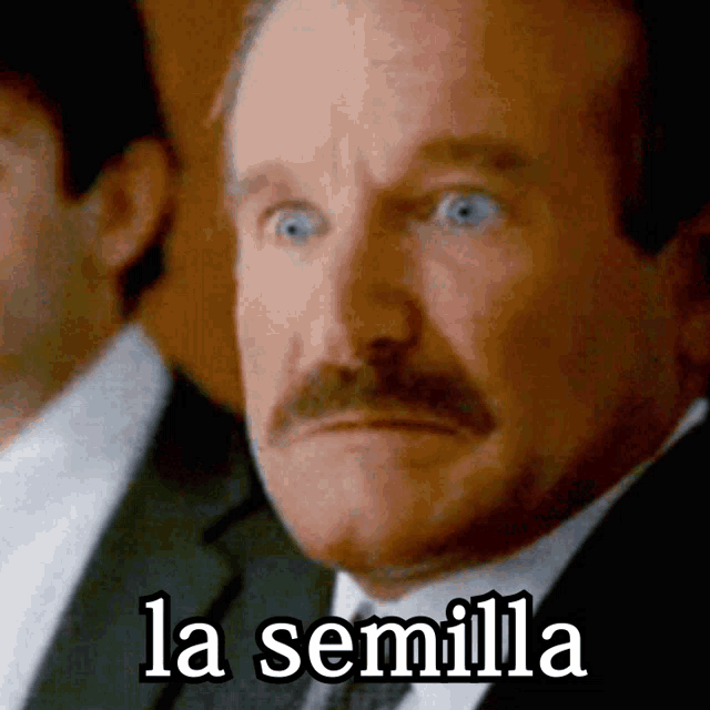 a man with a mustache is looking at the camera with the words la semilla above him